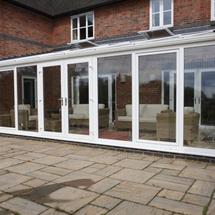 White glazed extension with wicker chairs and table
