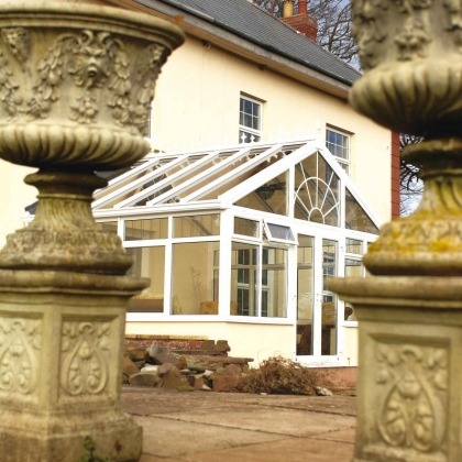 White glazed extension with stone pillars