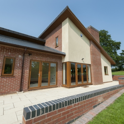 House in the countryside with woodgrain Bi-Fold doors