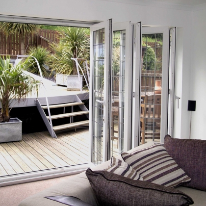 uPVC white Bi-Fold doors leading out onto a patio
