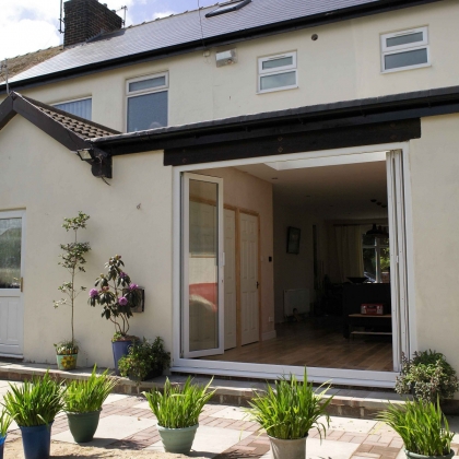 Back of a house with white PVCu Bi-Fold Doors